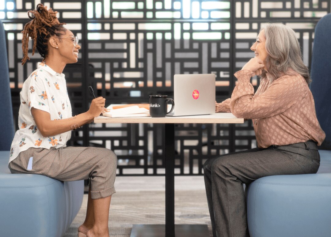 Splunker mentor and mentee sit discussing learning and development opportunities.