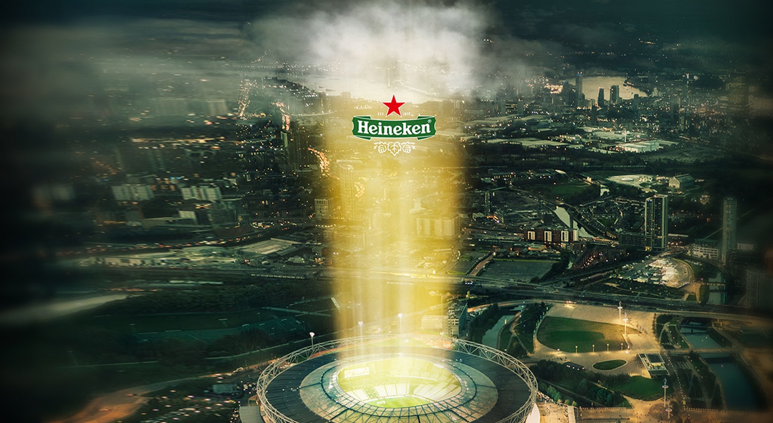Heineken glass overlaid on cityscape at twilight
