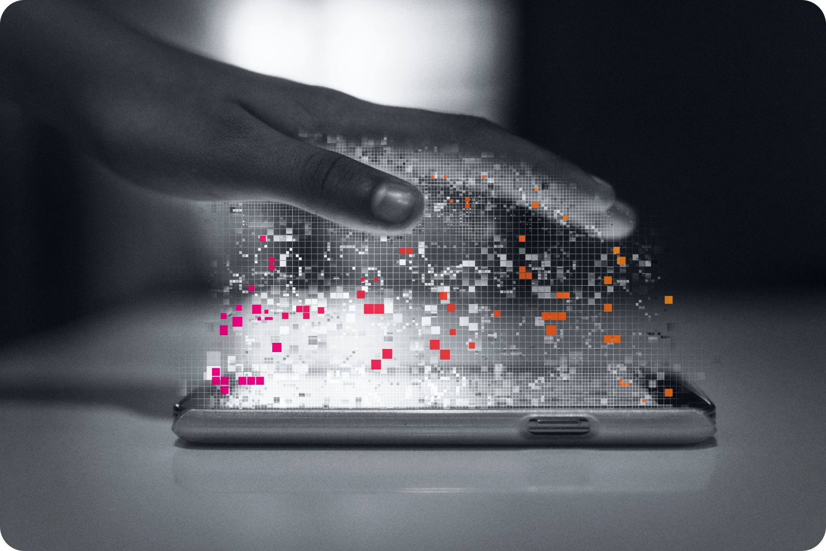 Hand hovering over mobile device