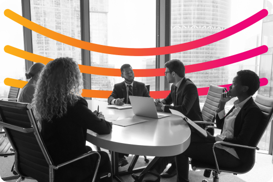 people smiling at a table over coffee