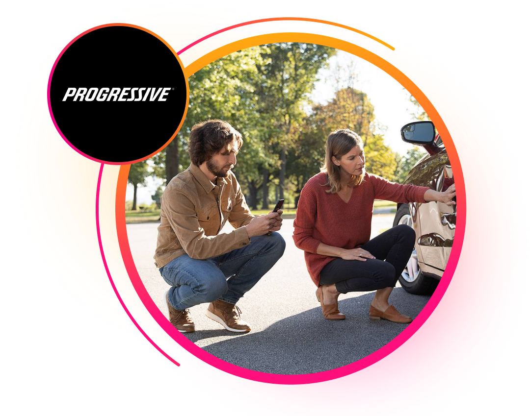 Two people looking at damage on the side of a car.