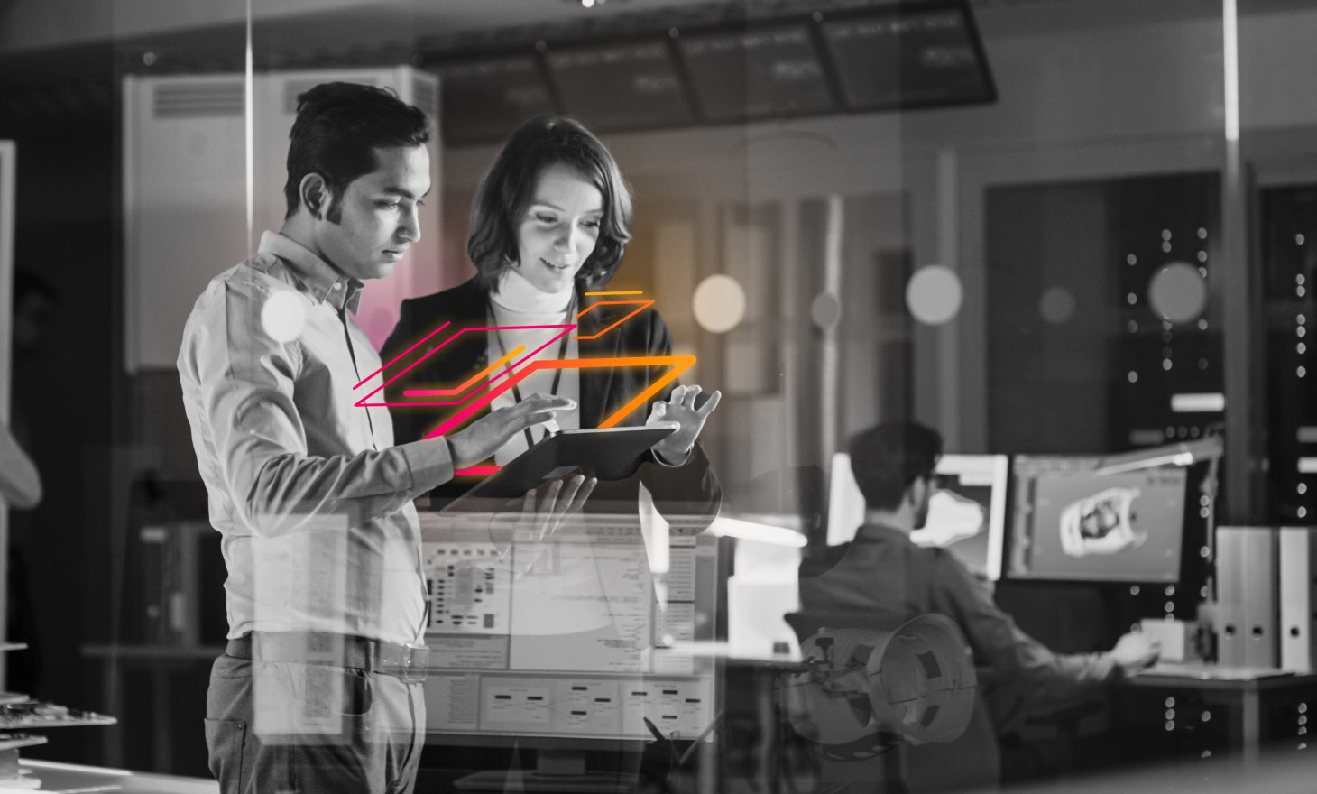 Two professionals in an office look at a shared computer tablet that seems to be radiating pink and orange light.